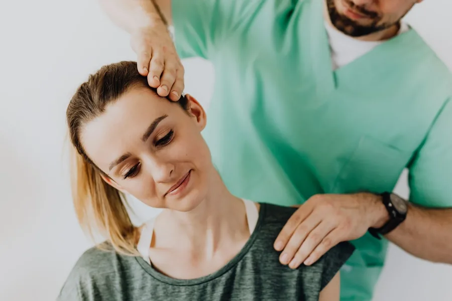 A clinician assessing a patient's neck