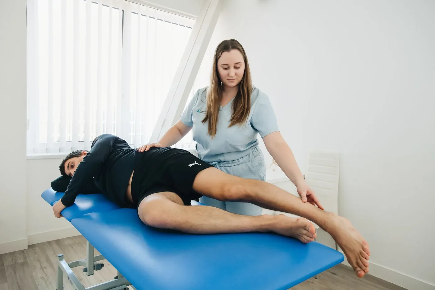 A physiotherapist treating a patient on a treatment table