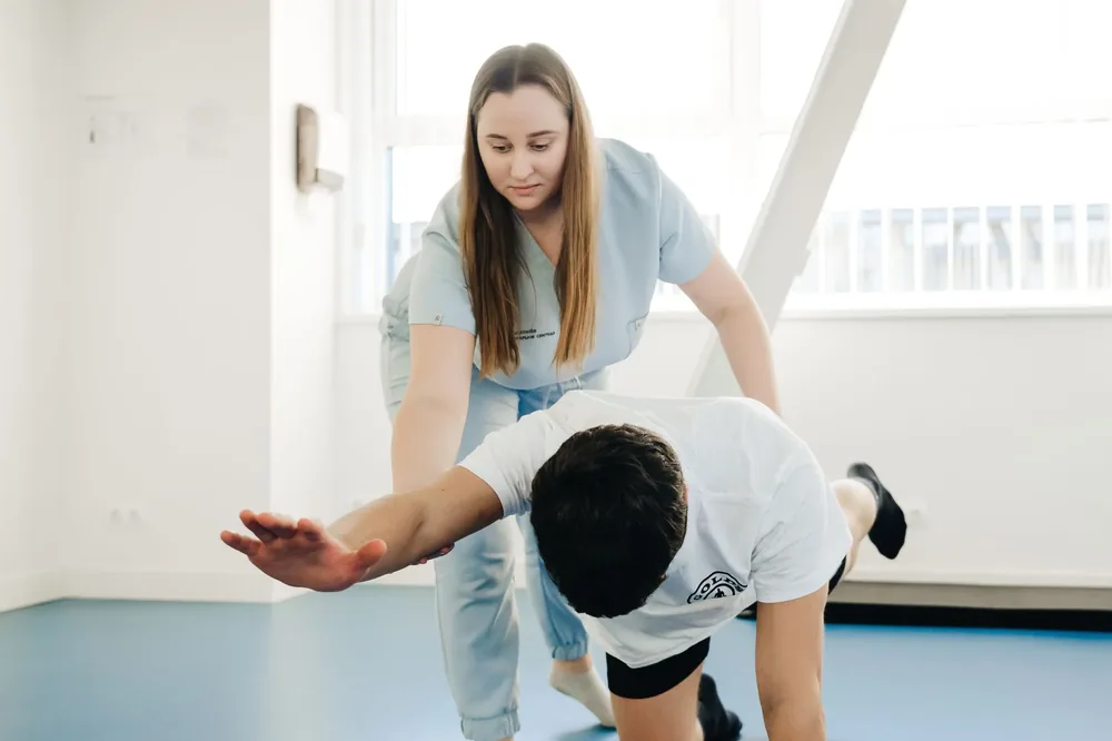 A physio coaching a patient through an exercise