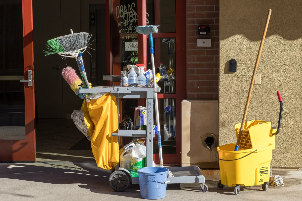A mop bucket and cleaning cart