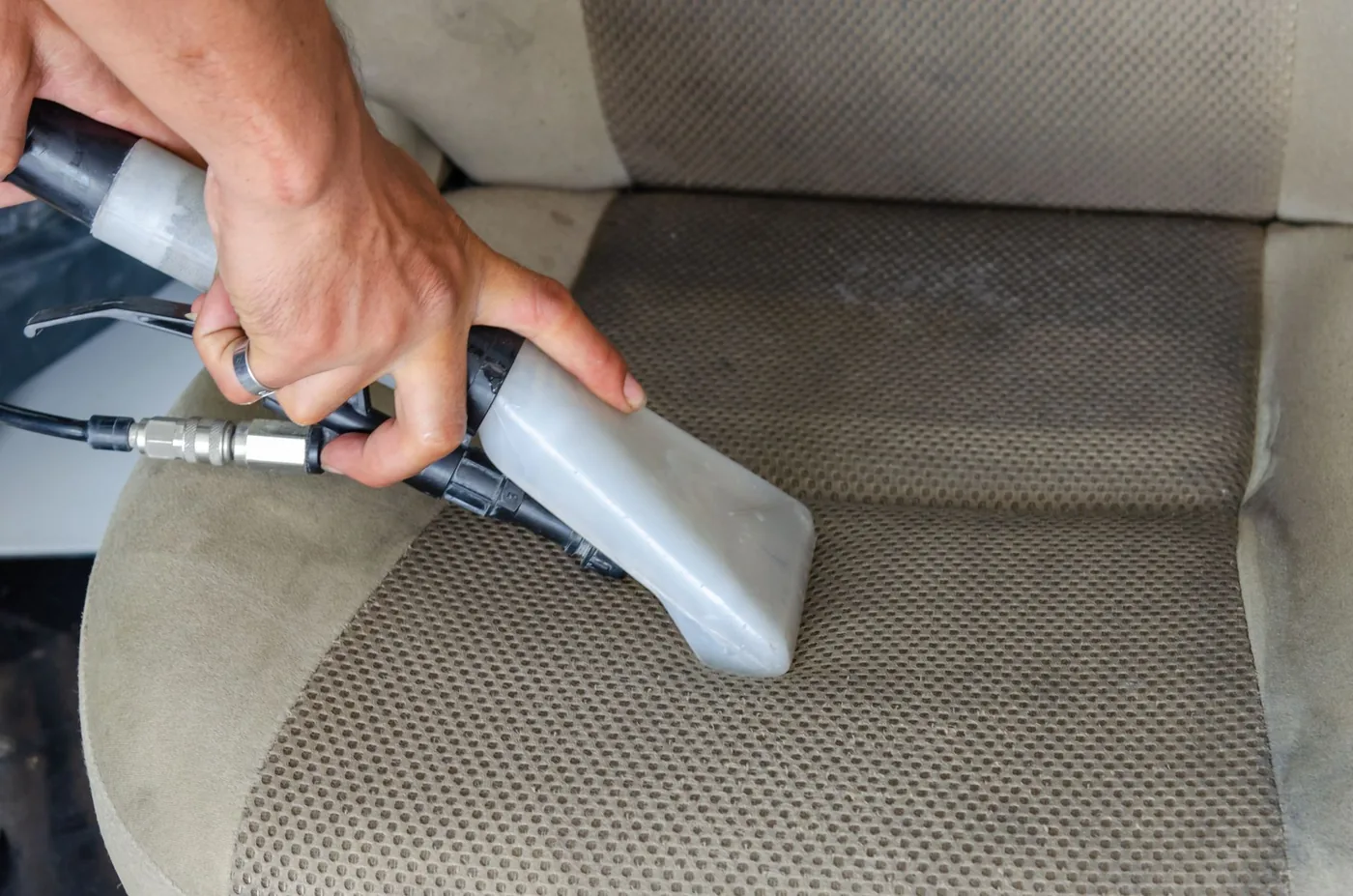 Hot water extraction being run through a car seat