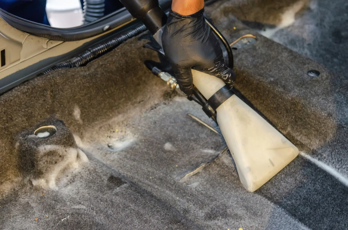 A car footwell being extracted before the clean