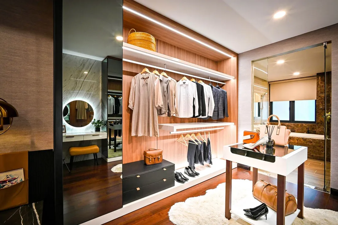 A lit walk in dressing room with open shelving