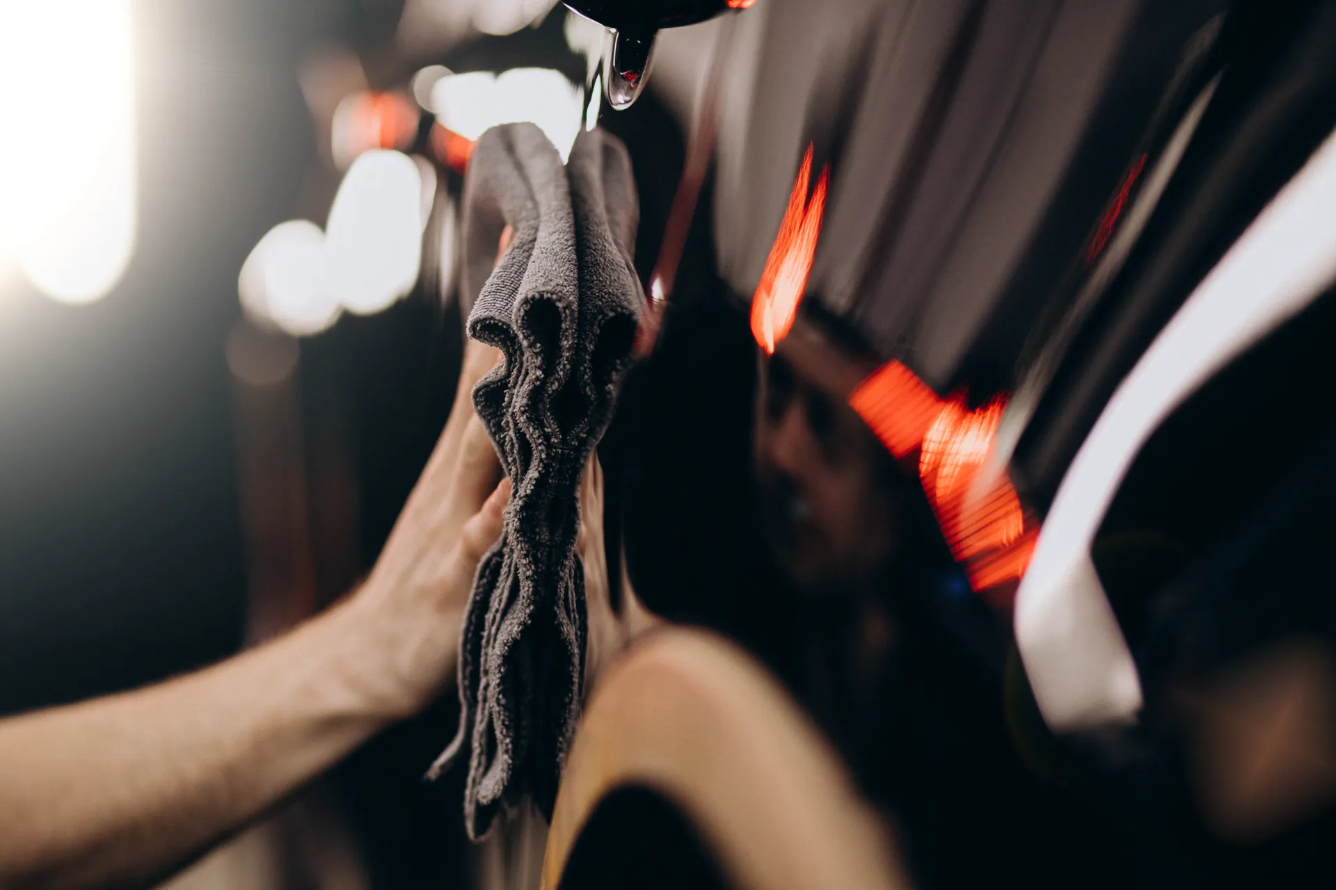 Polisher working across a car bonnet