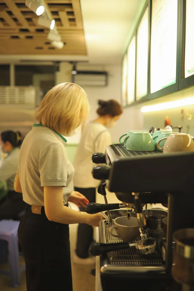 A barista working the espresso machine