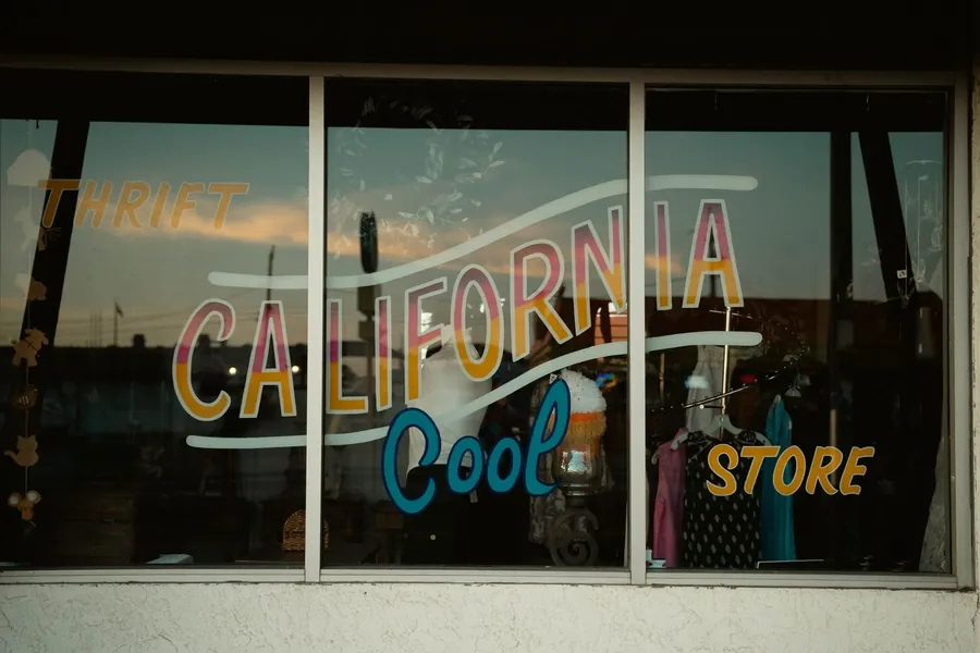 Hand painted gold and white lettering across a shop window