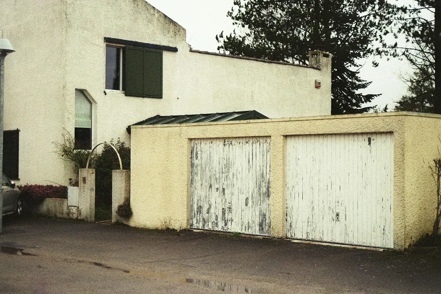 A weathered old garage door due for new springs