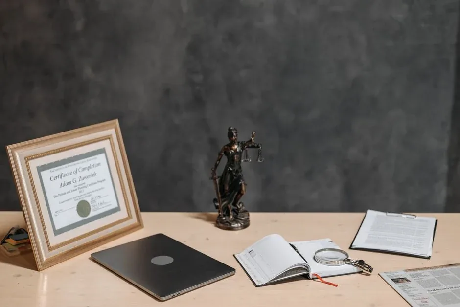A notary's desk with a framed commission certificate and a journal