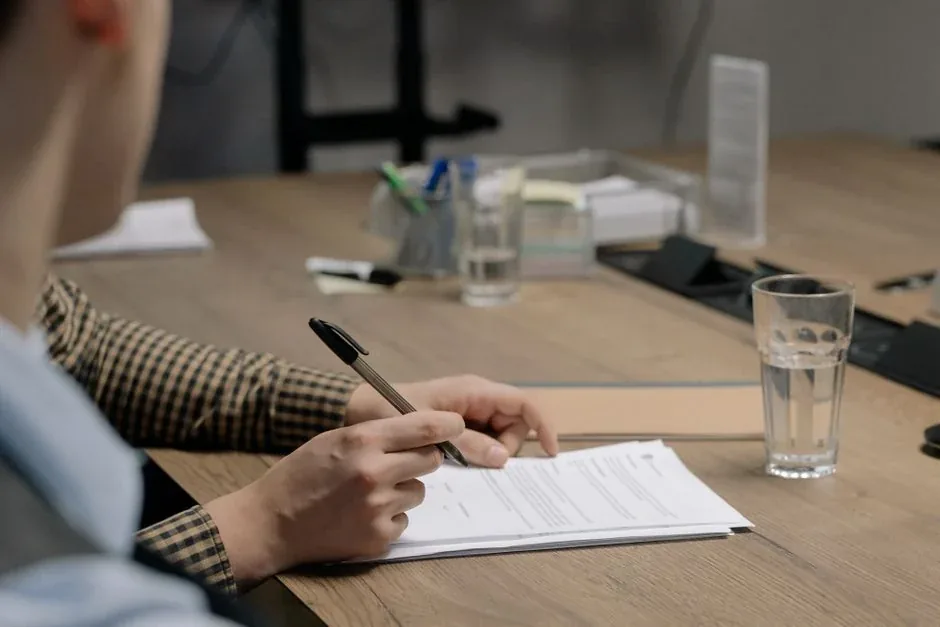 A signer working through a document at a table