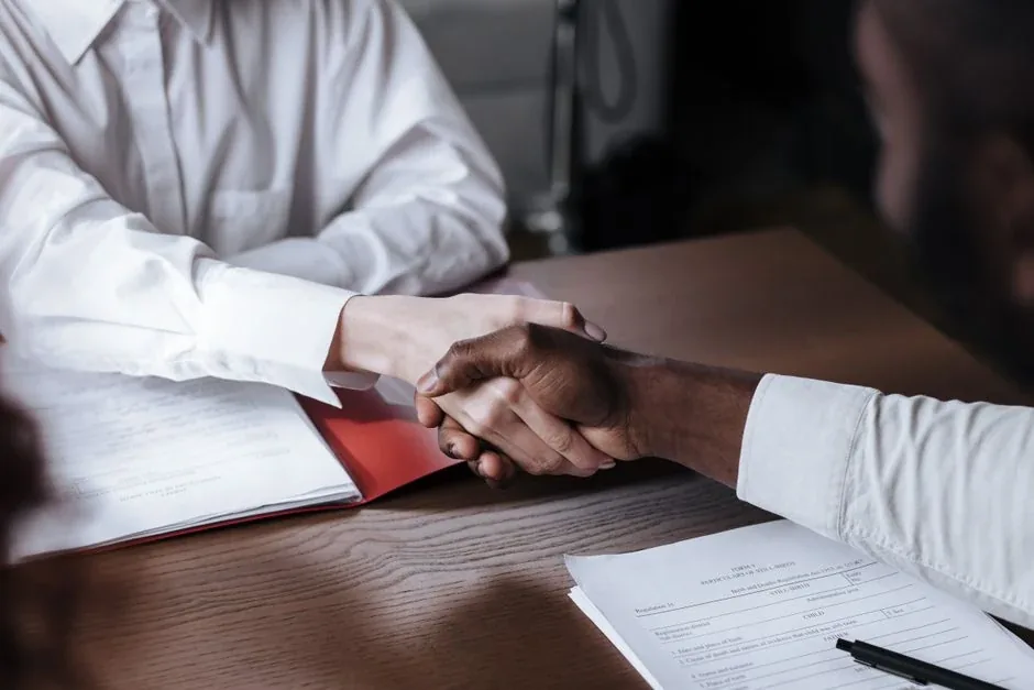 A handshake over the finished paperwork
