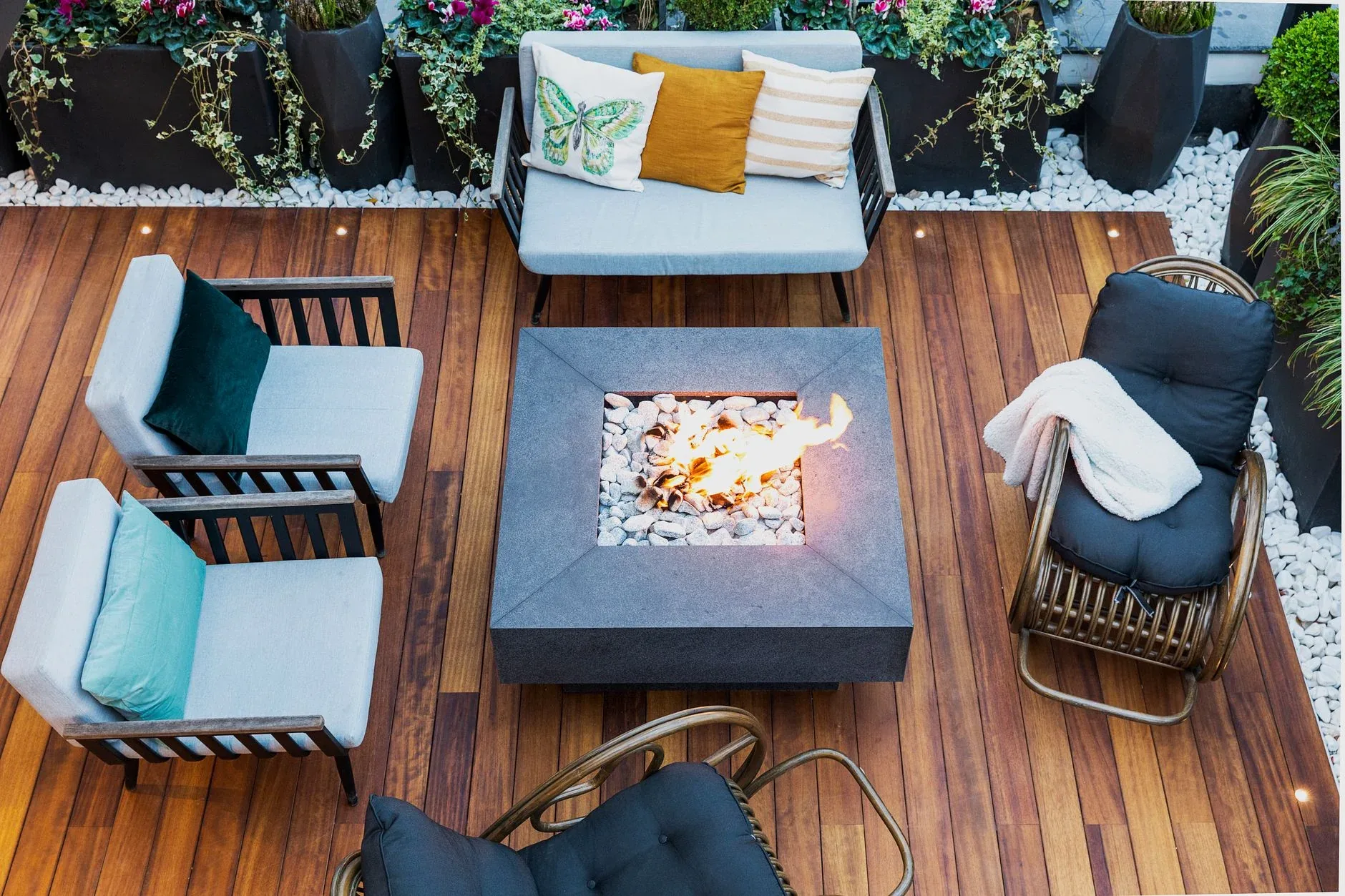 A new hardwood deck with outdoor seating and a fire table