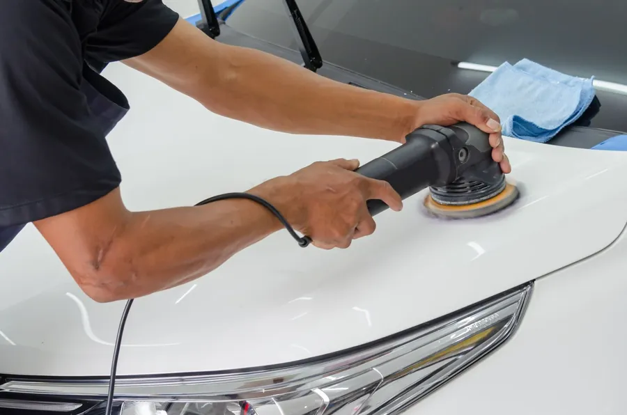 A machine polisher working on a white bonnet