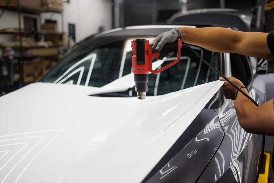 A heat gun used to set wrap film on a car bonnet