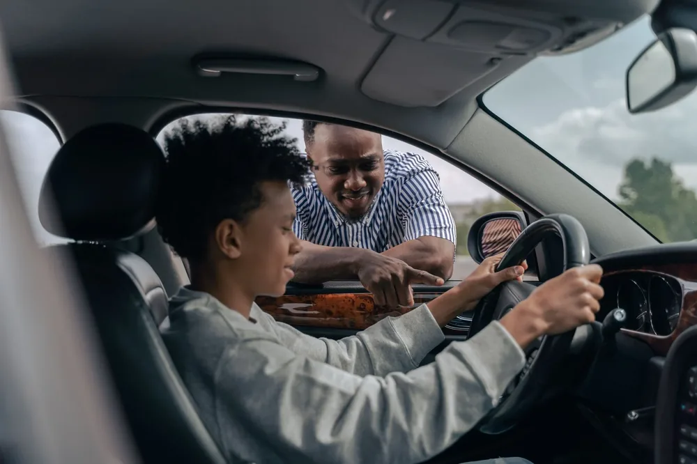 An instructor at the window coaching a learner