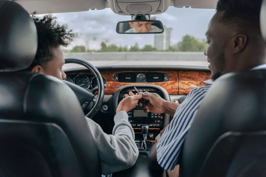 An instructor handing over the keys