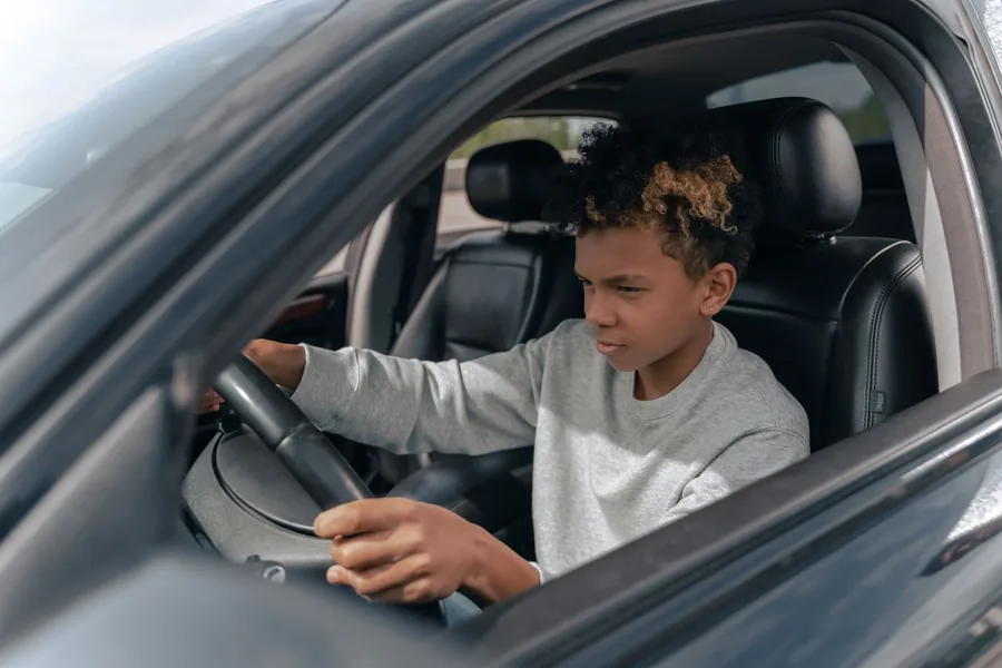 A teen learner concentrating at the wheel