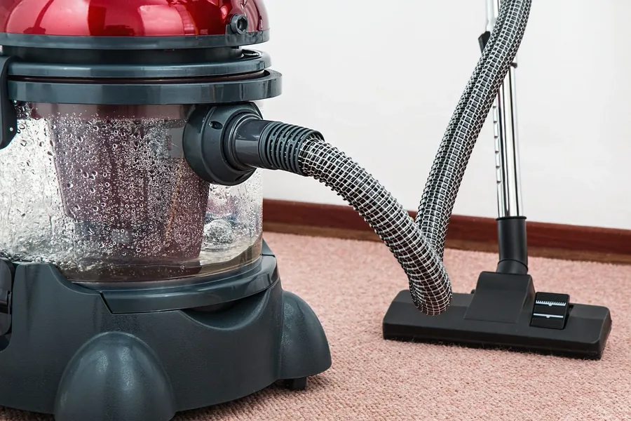 A wet vacuum extracting water from carpet