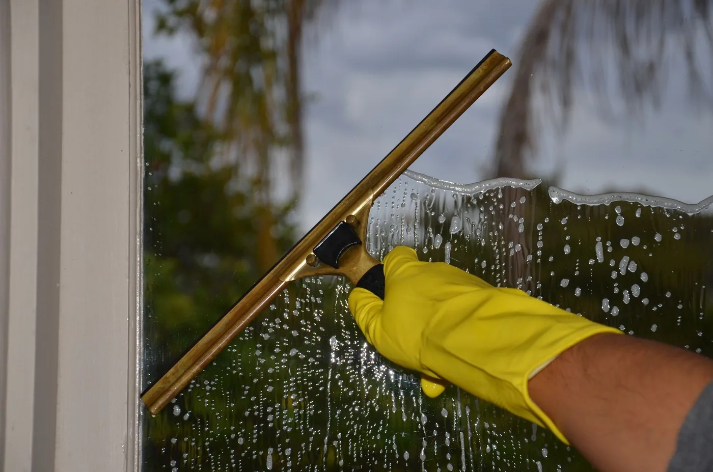 Squeegee drawn across soapy glass