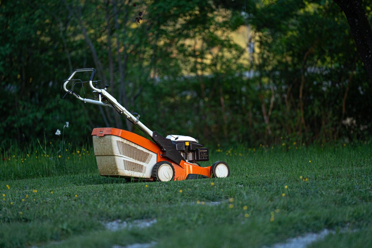 A mower on damp spring grass