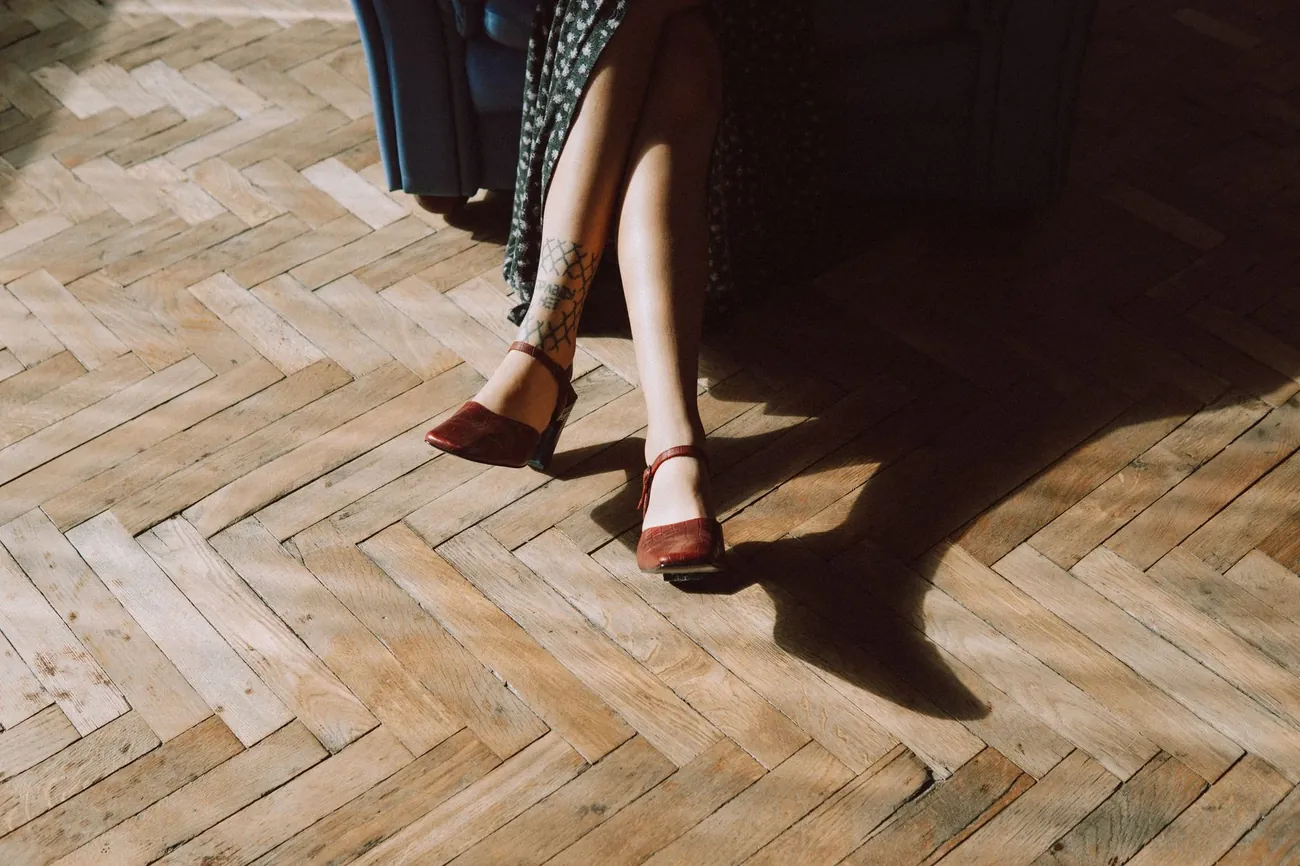 Someone walking across a light oak herringbone floor