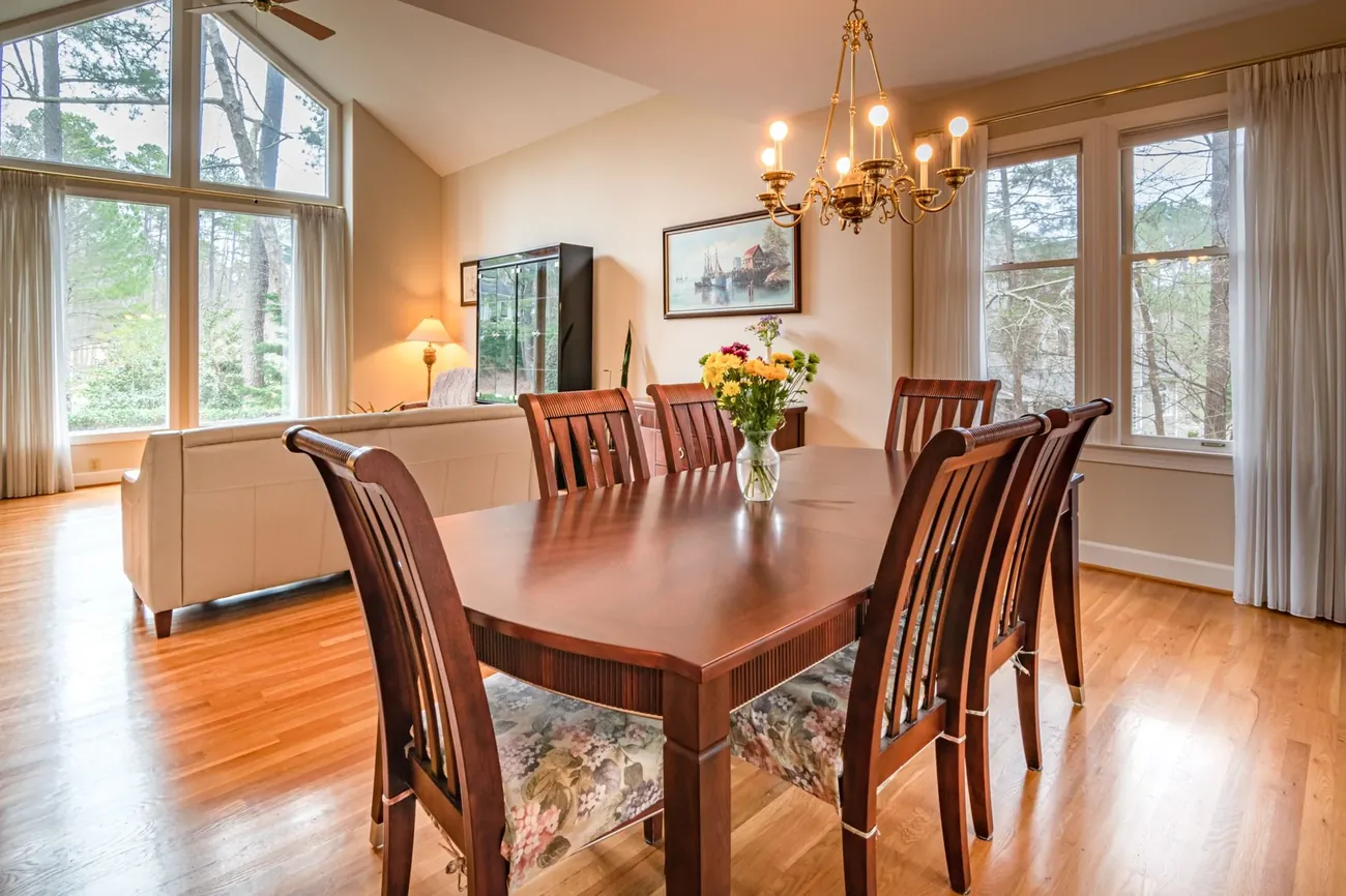 A dining room with honey red oak floors and afternoon light