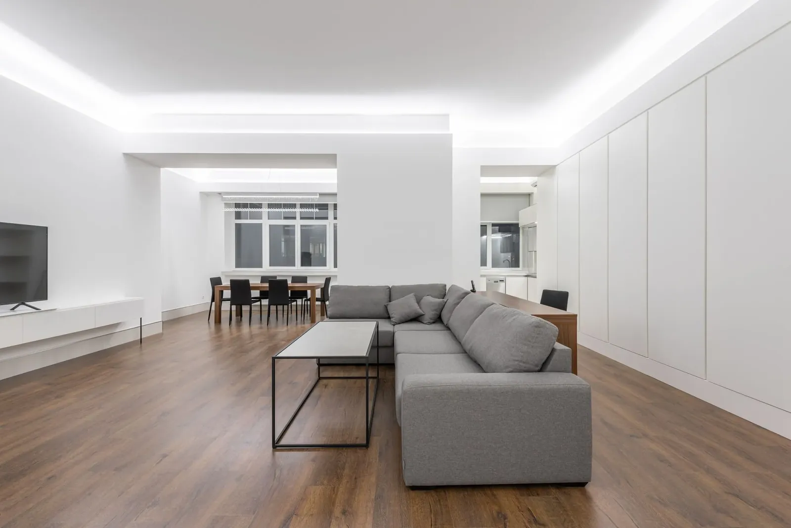 An open plan room with weathered grey vinyl plank floors