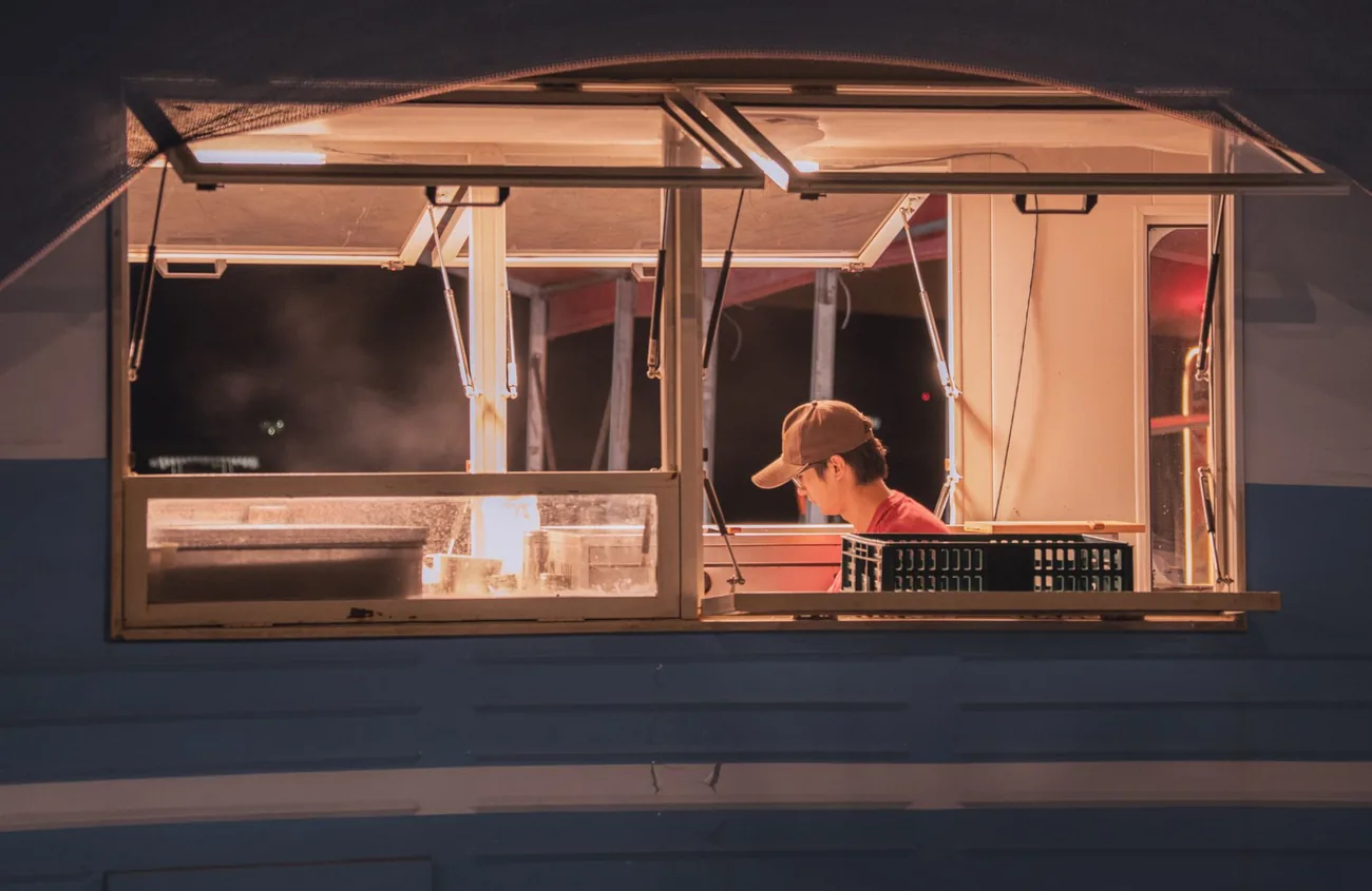 The truck lit up and serving at dusk
