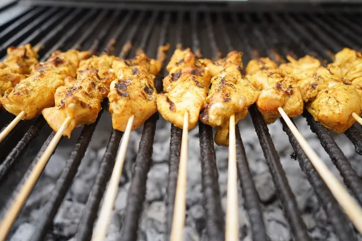 Chicken skewers over charcoal