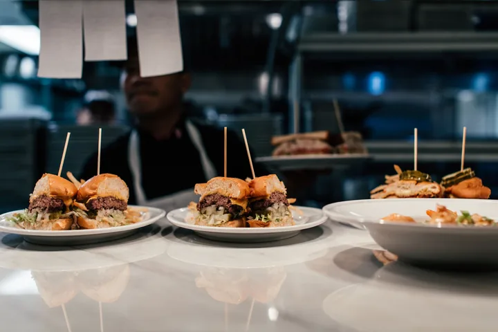 A flight of three sliders on plates