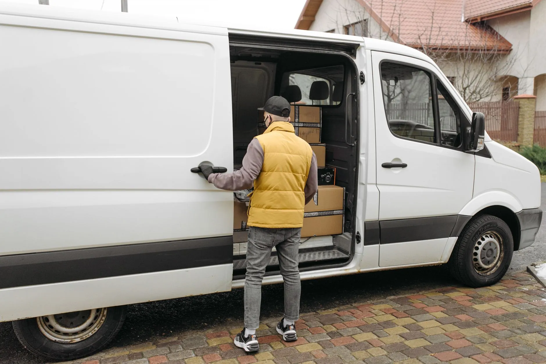 A Kerbside crew member loading the van outside a house