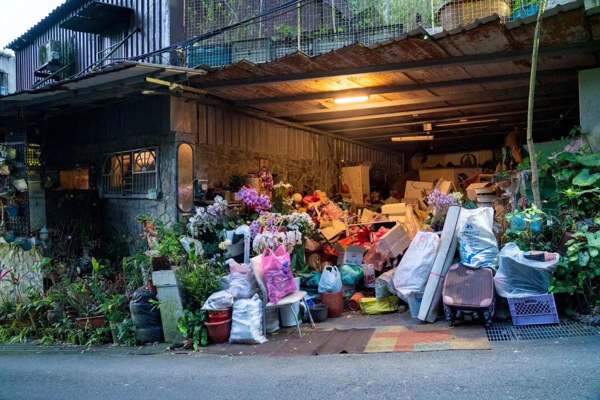 A garage and yard piled high with bags and junk