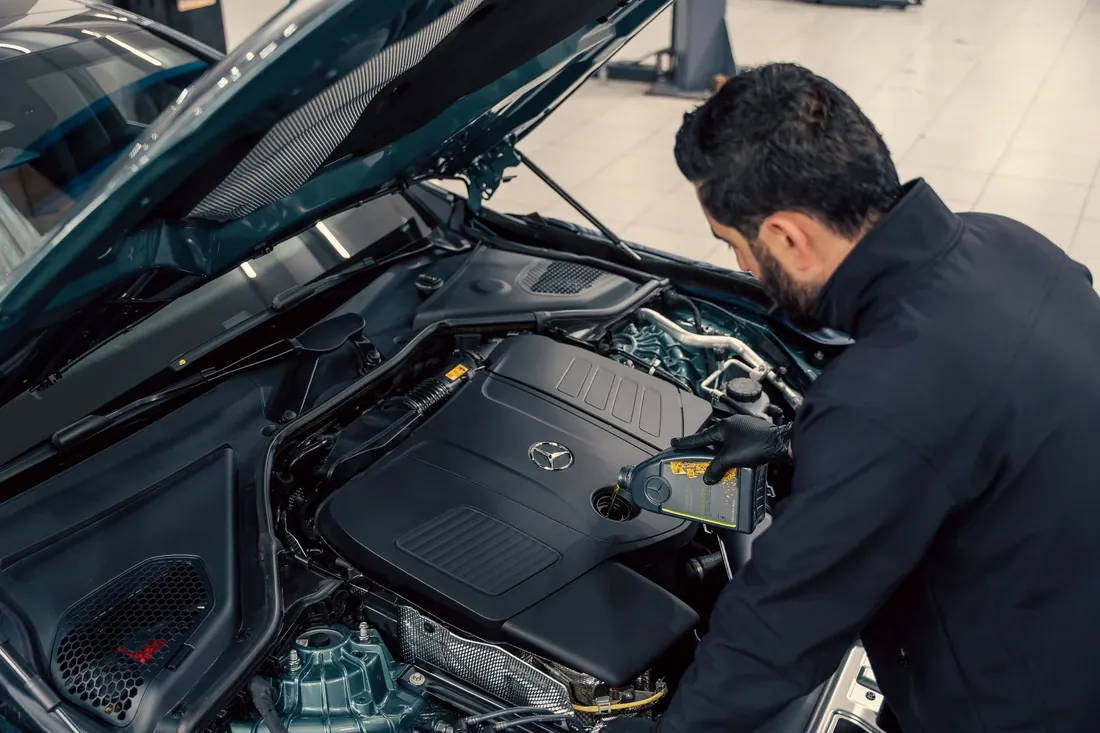 A mechanic working in an open engine bay