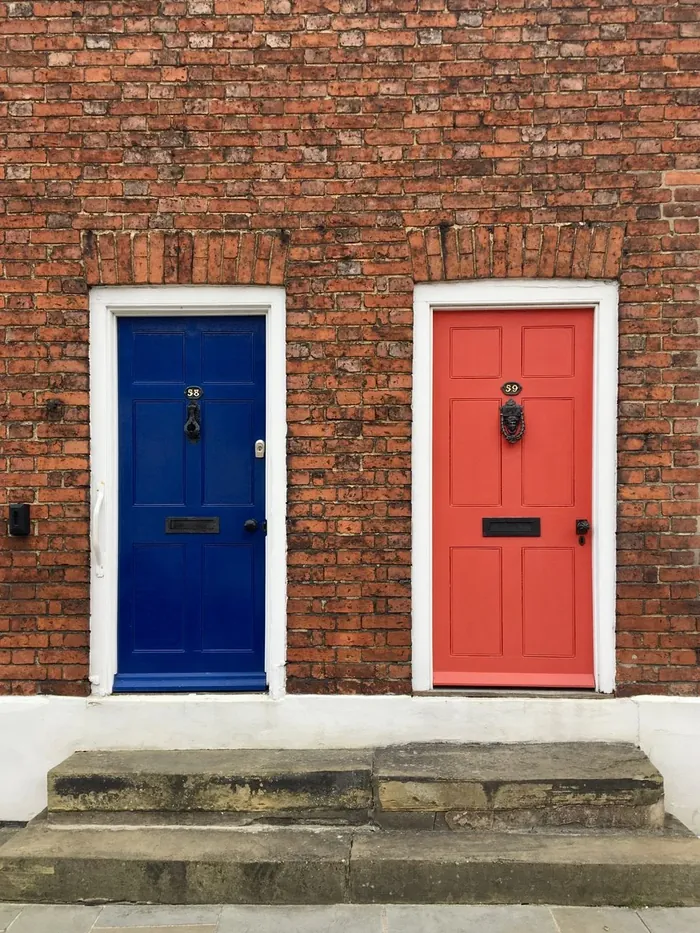 A blue and a red front door side by side