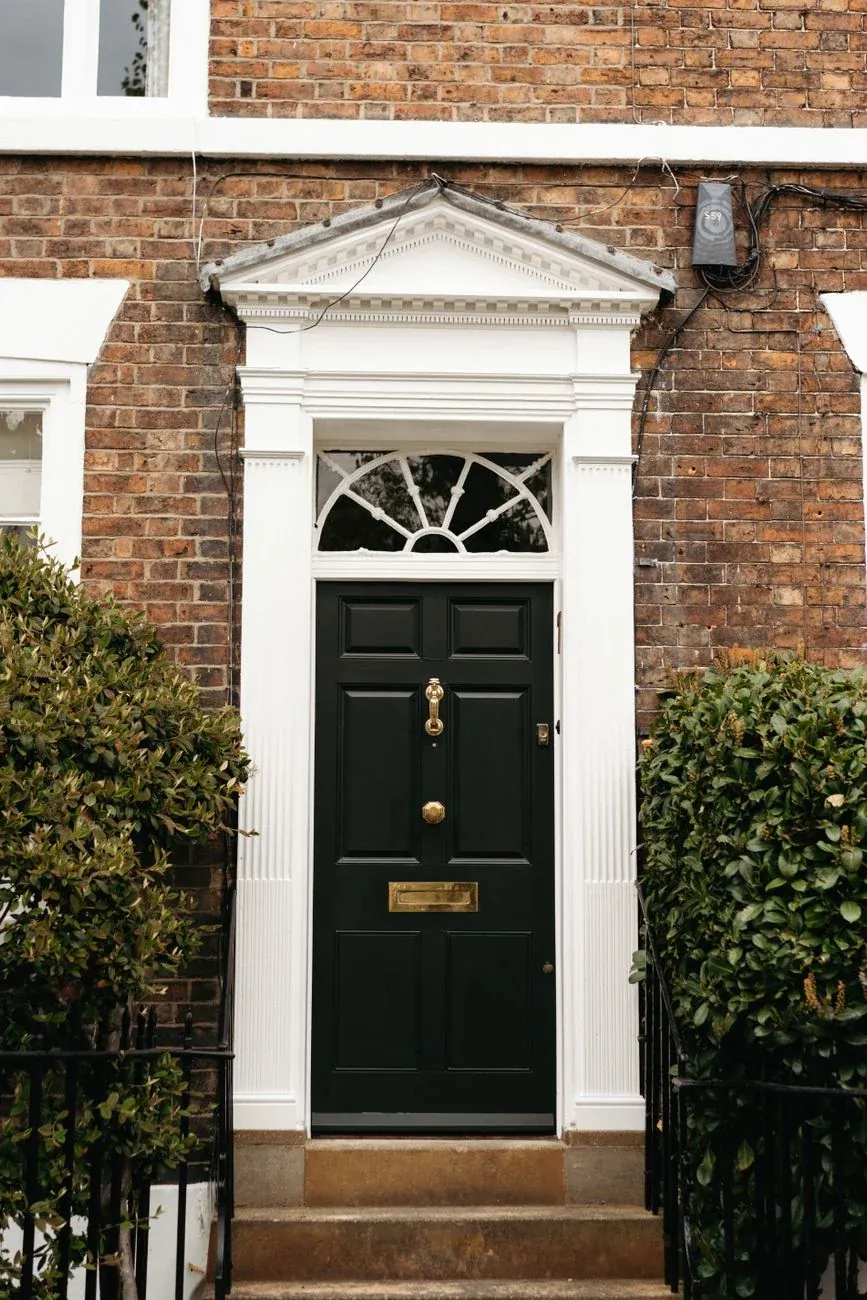 A black Georgian front door with a fanlight
