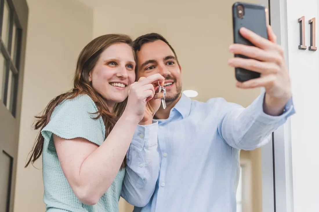 A couple holding up the keys to their new house