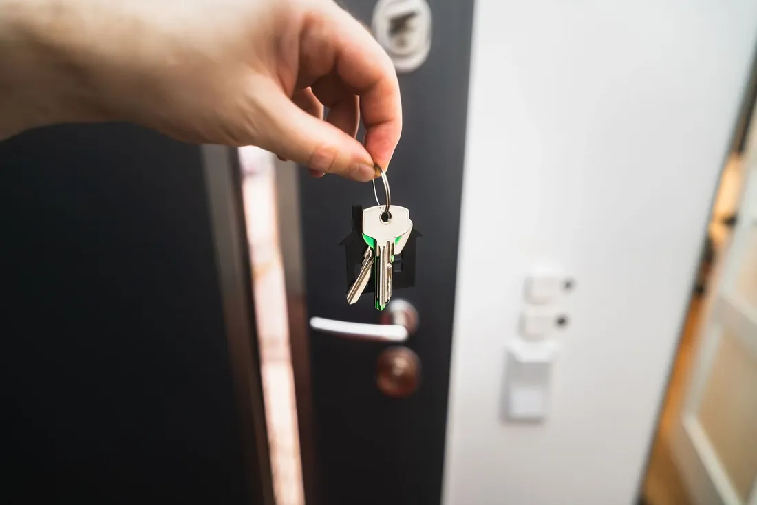 A key being turned in a front door lock