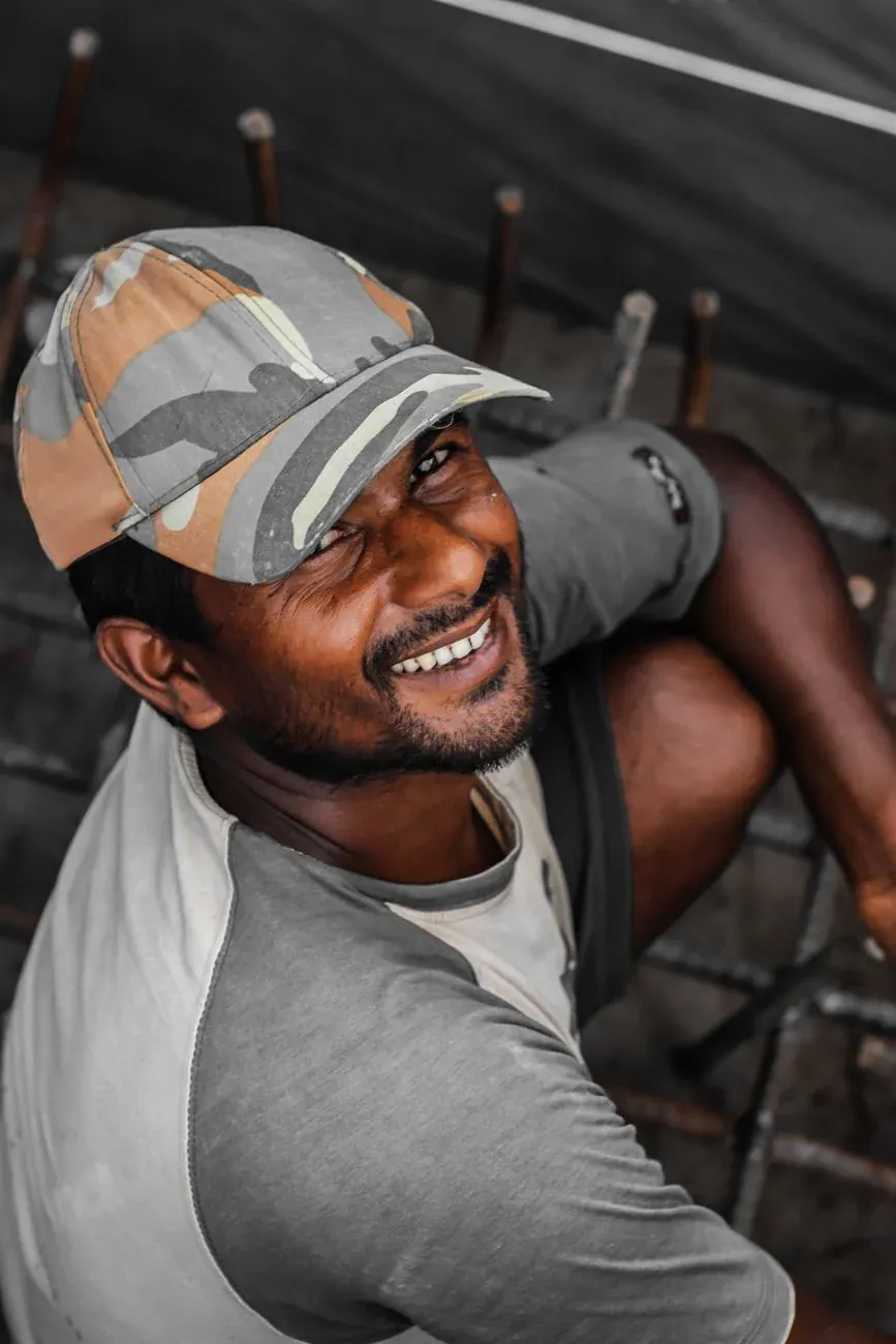 Joel Asante, smiling, in a cap