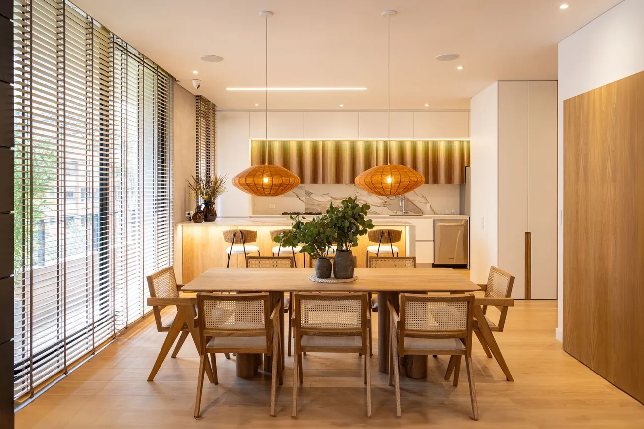 A dining room with tall windows and wooden panels