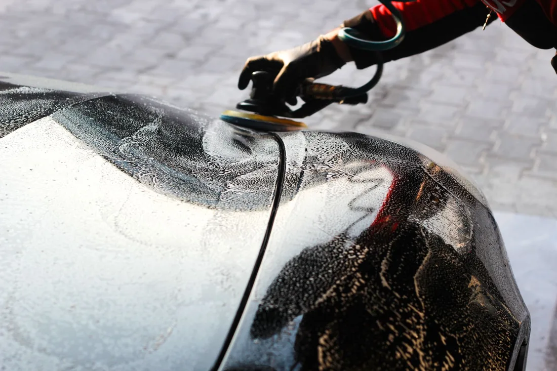 A machine polisher on a wet panel