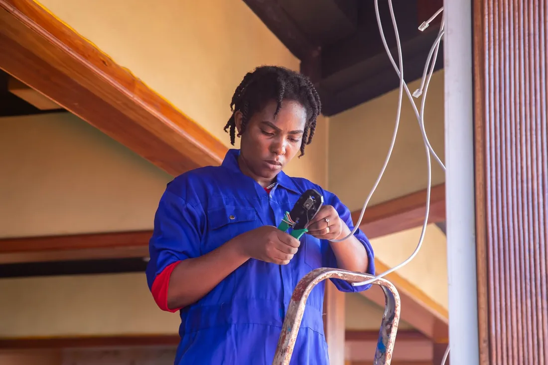 A Lumenfield electrician stripping cable for a first fix