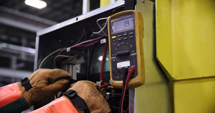 An electrician testing a circuit with a multimeter