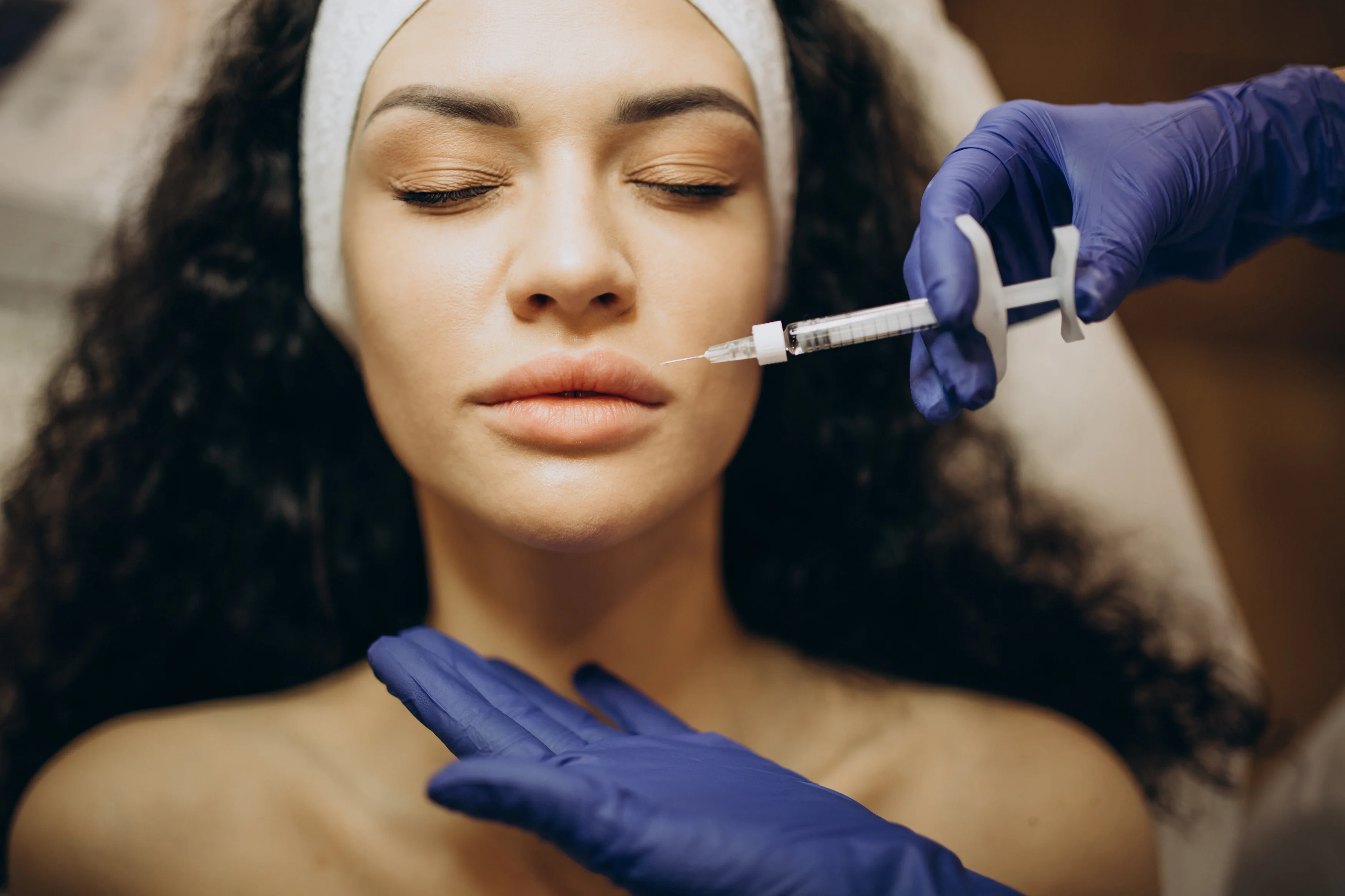 Practitioner administering a facial injection