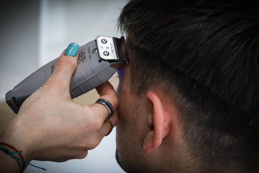 A barber working a clipper fade