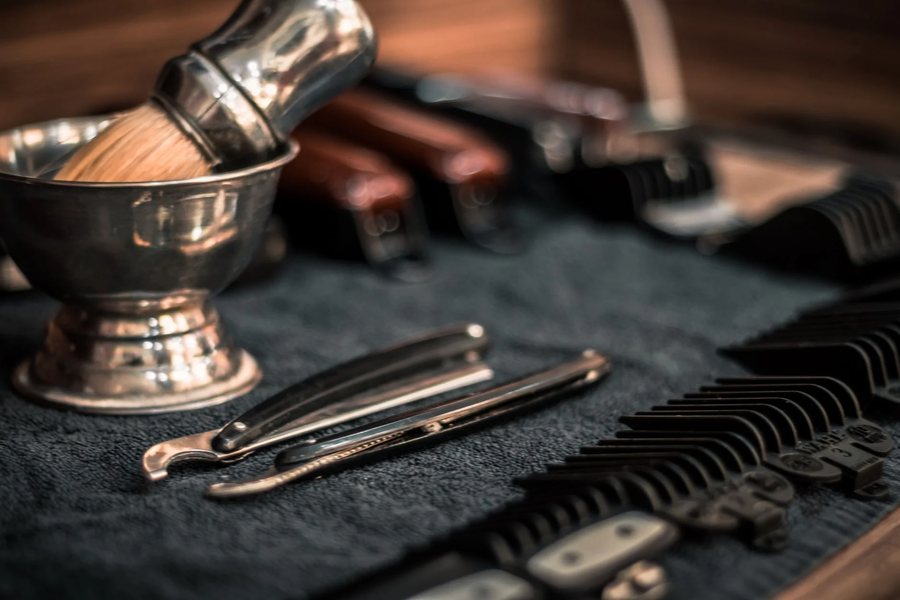 A shaving brush and barber tools laid out
