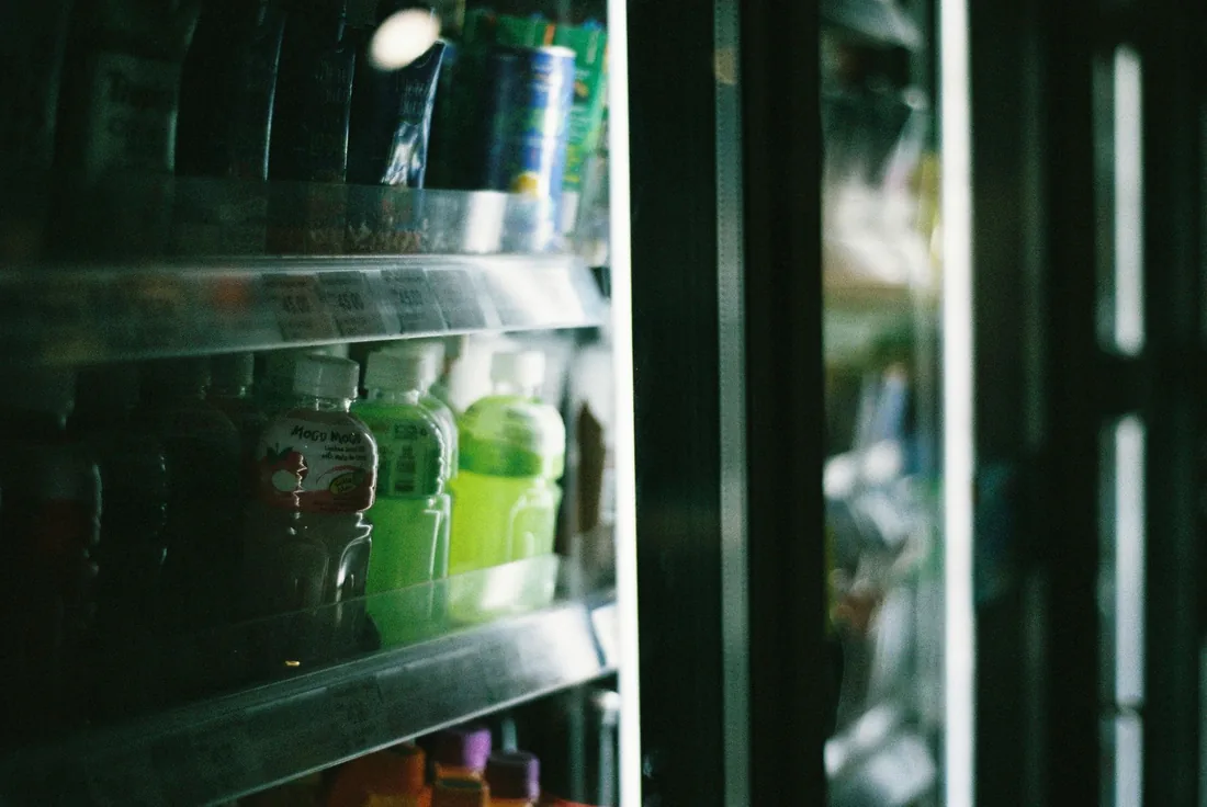 A chilled drinks machine stocked and lit