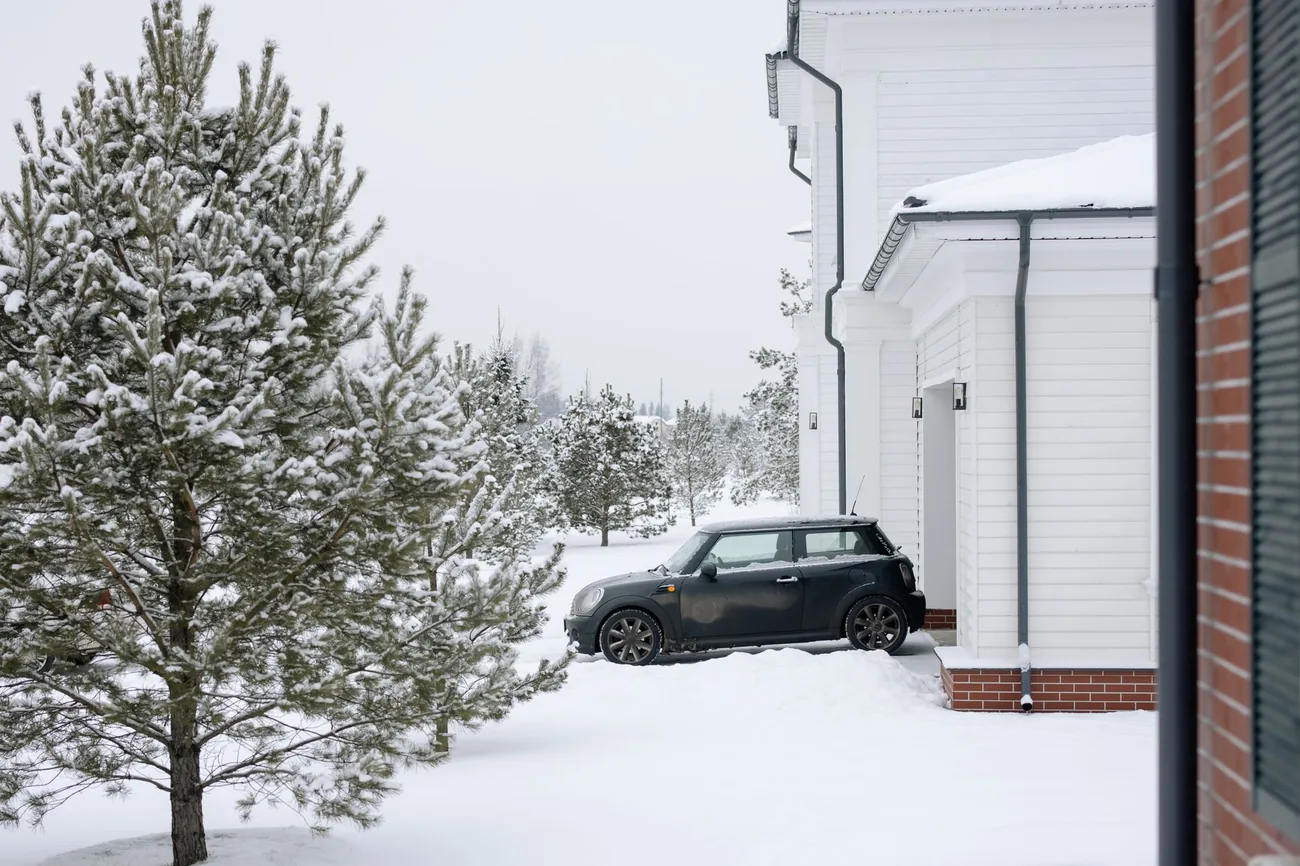 A plow truck working a road in falling snow