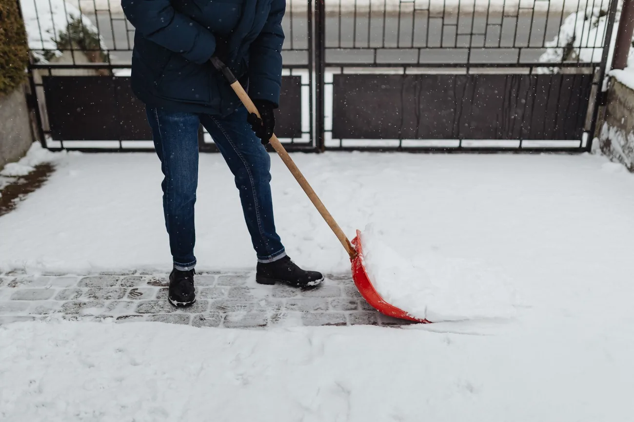 Clearing a residential walk with a shovel after heavy snow
