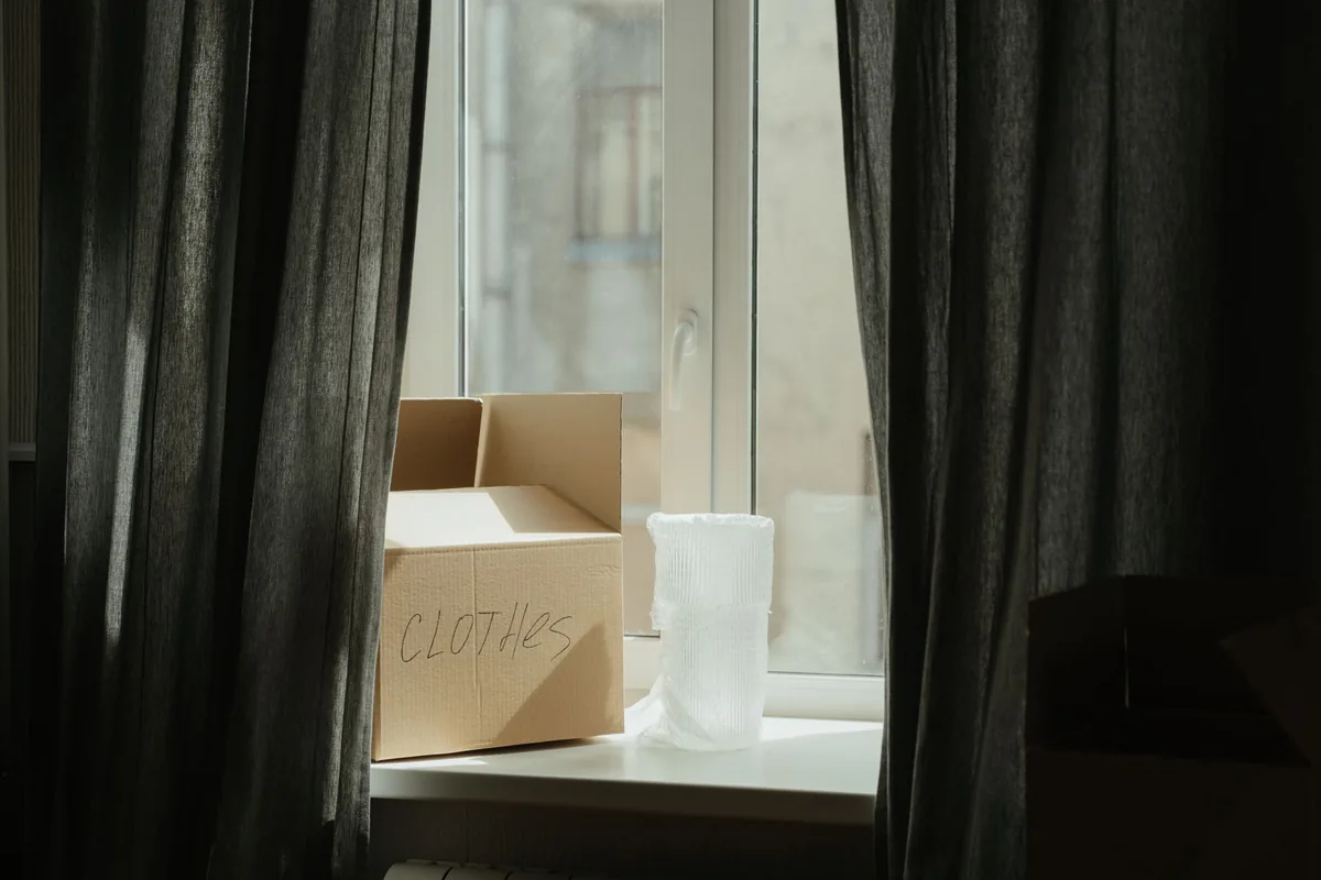 A packed box waiting by a window