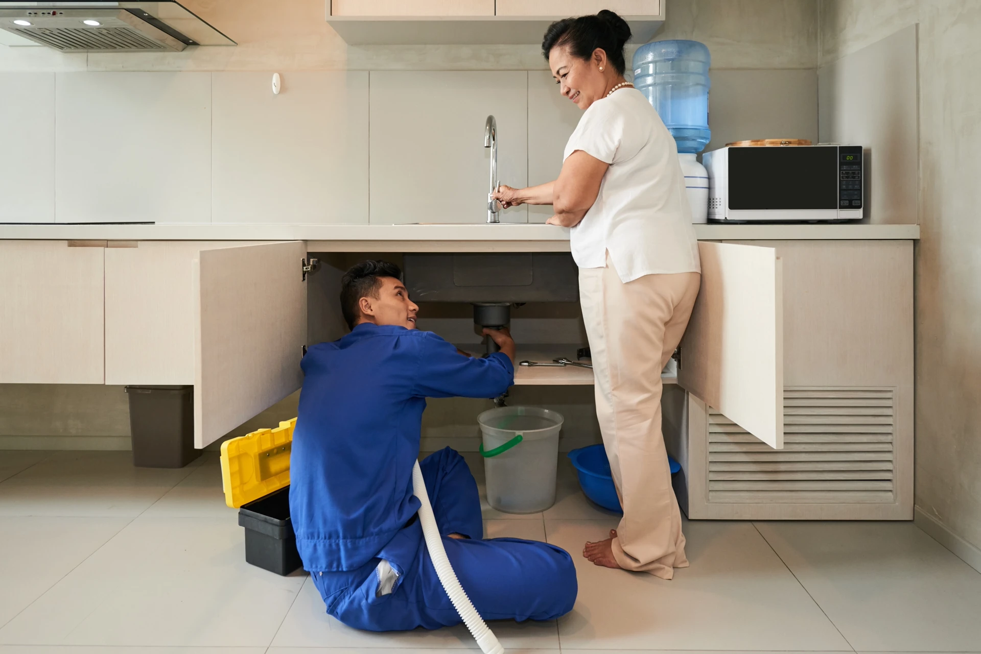 Plumber using leak detection equipment