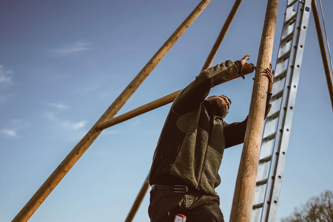 Worker at height beside a roofline